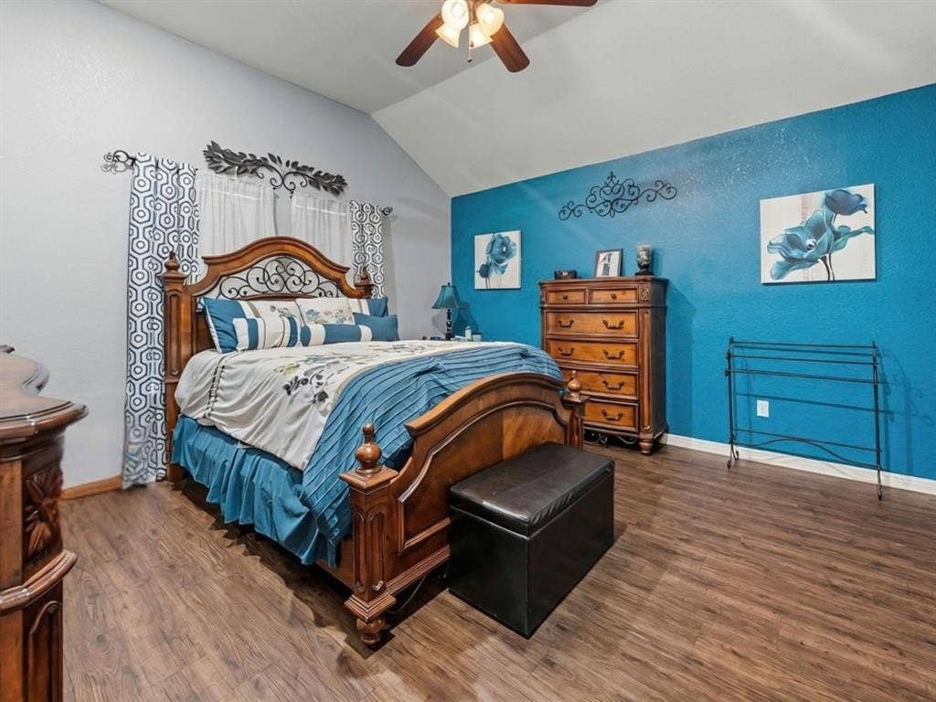 3012 Pinto Loop, Robinson, TX 76706 Vaulted ceiling with an attached ceiling fan, wood-finish flooring, and a decorative accent wall