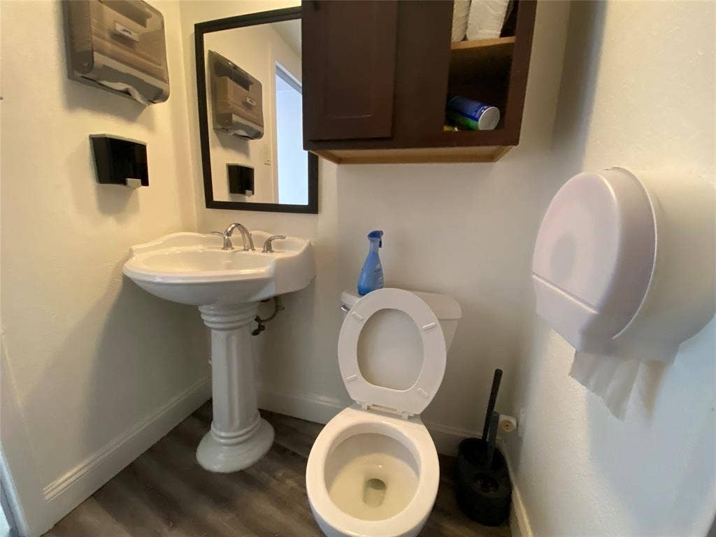7041 Military Parkway, Dallas, TX 75227 Bathroom featuring toilet and hardwood / wood-style flooring