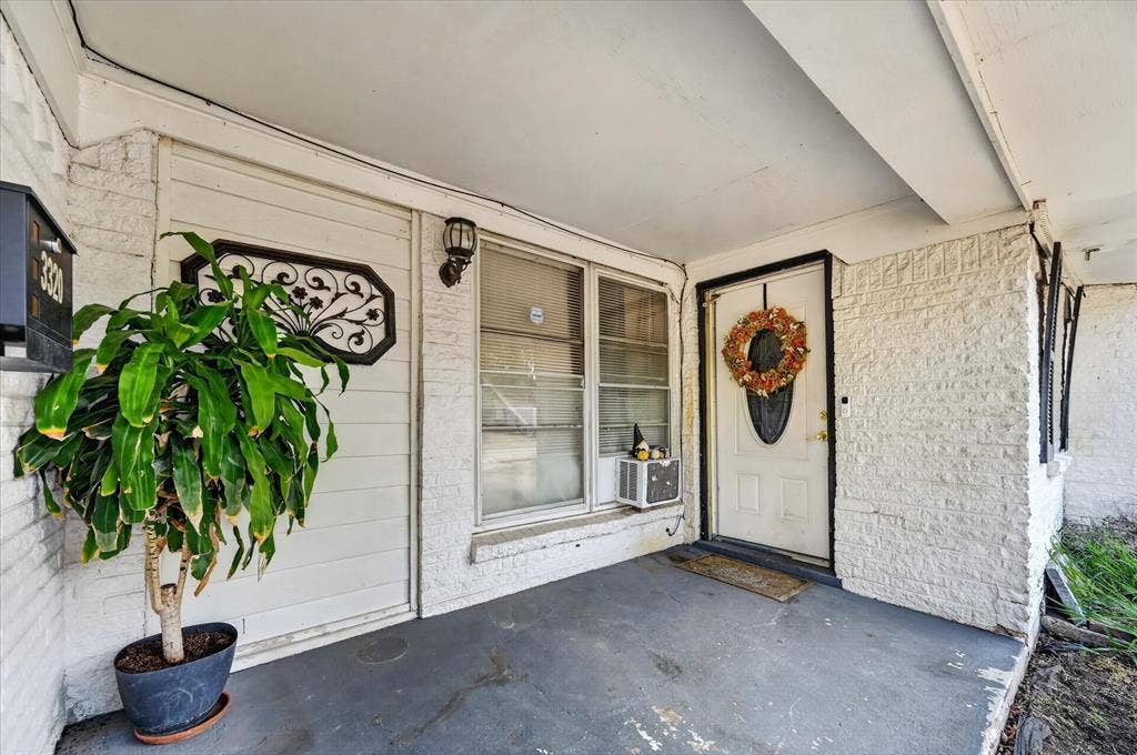 3320 Shorewood Drive, Mesquite, TX 75150 Covered front porch with white painted brick siding and a white entry door