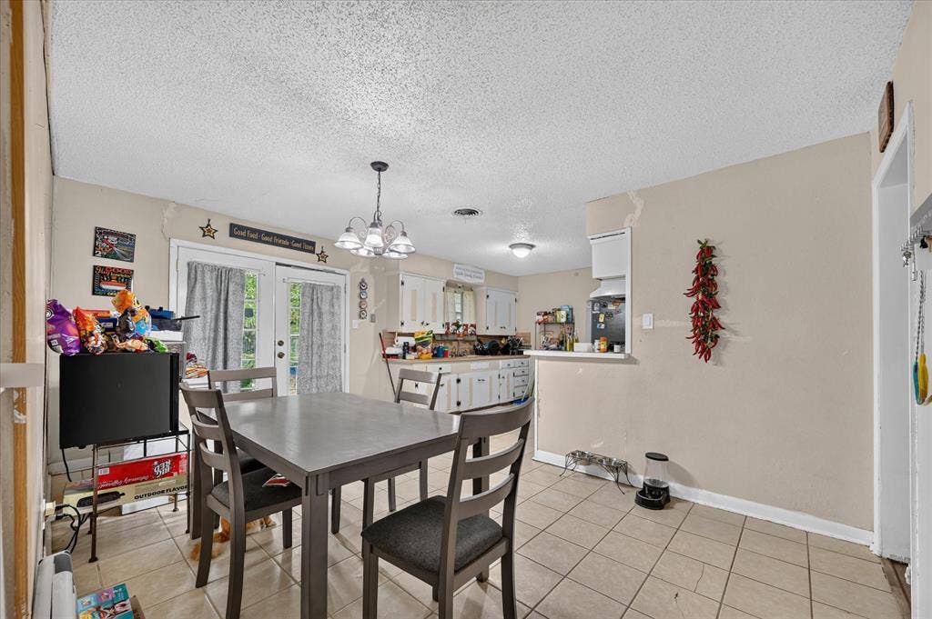 3320 Shorewood Drive, Mesquite, TX 75150 Tiled flooring, white french doors, and a kitchen pass-through window