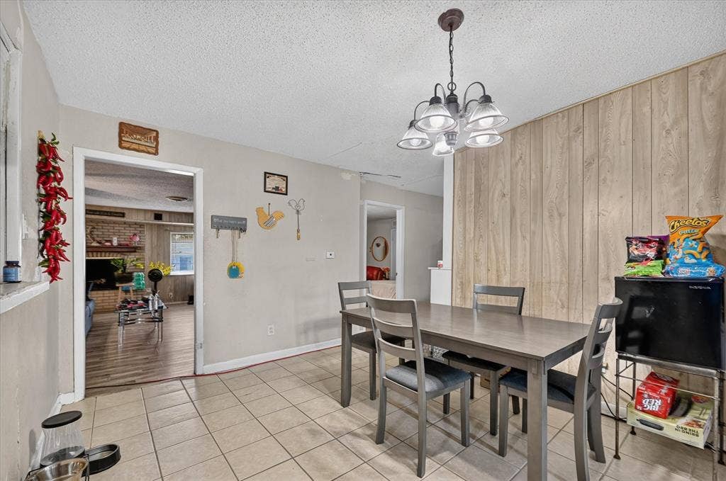 3320 Shorewood Drive, Mesquite, TX 75150 Tile flooring, recessed lighting, and a wood-paneled accent wall