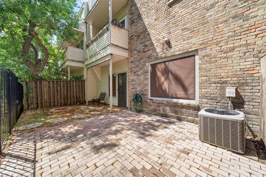 7340 Skillman Street, #909, Dallas, TX 75231 Brick exterior with a ground-level patio featuring a paver surface