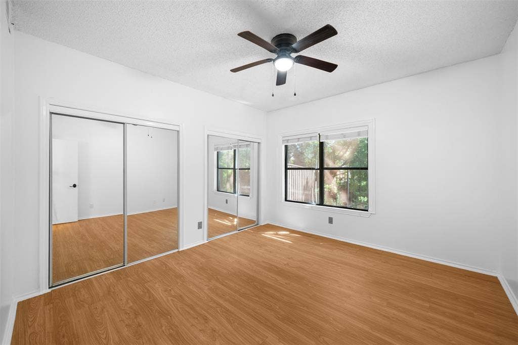 7340 Skillman Street, #909, Dallas, TX 75231 Wood-finish flooring, mirrored sliding closet doors, ceiling fan with light, and dual windows