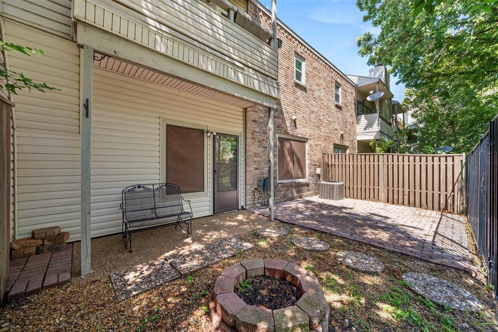 7340 Skillman Street, #909, Dallas, TX 75231 Rear patio with brick pavers, fire pit, and privacy fencing