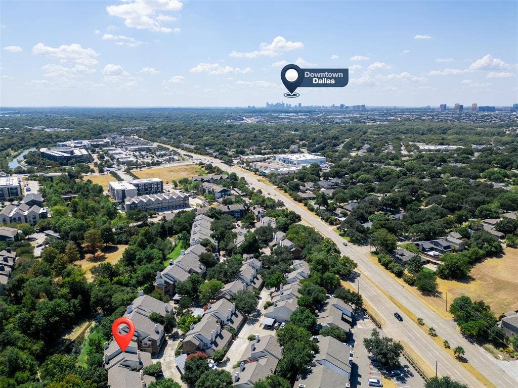 7340 Skillman Street, #909, Dallas, TX 75231 Aerial perspective showcasing urban surroundings with a prominent city skyline in the distance