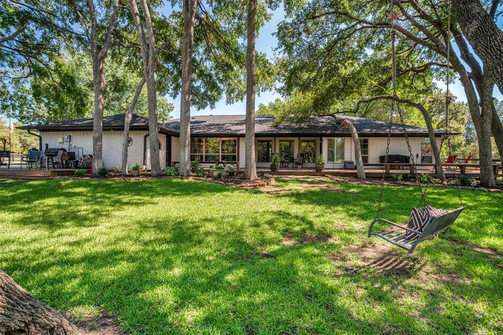 18 Brookhaven Drive, Lucas, TX 75002 Beautiful back view of this amazing home. Shaded back deck and stunning landscaping.