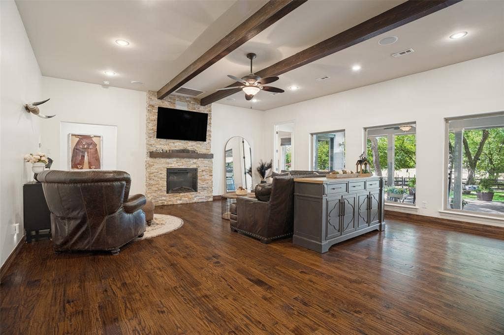 18 Brookhaven Drive, Lucas, TX 75002 So many upgrades to this beautiful home! The fireplace and wall of windows to the backyard are some of the homeowners' favorites.
