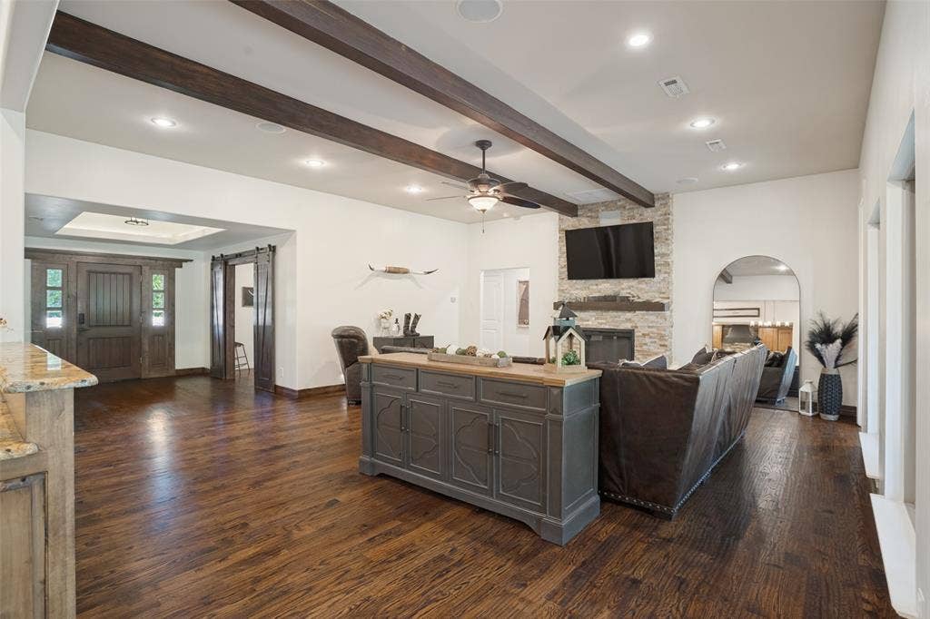 18 Brookhaven Drive, Lucas, TX 75002 Huge living area boasts can lighting, wood beamed ceilings, fresh paint, refinished wood flooring.