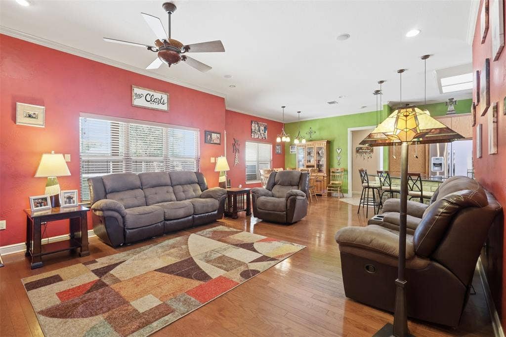 Hardwood-finish flooring, recessed lighting, and a ceiling fan
