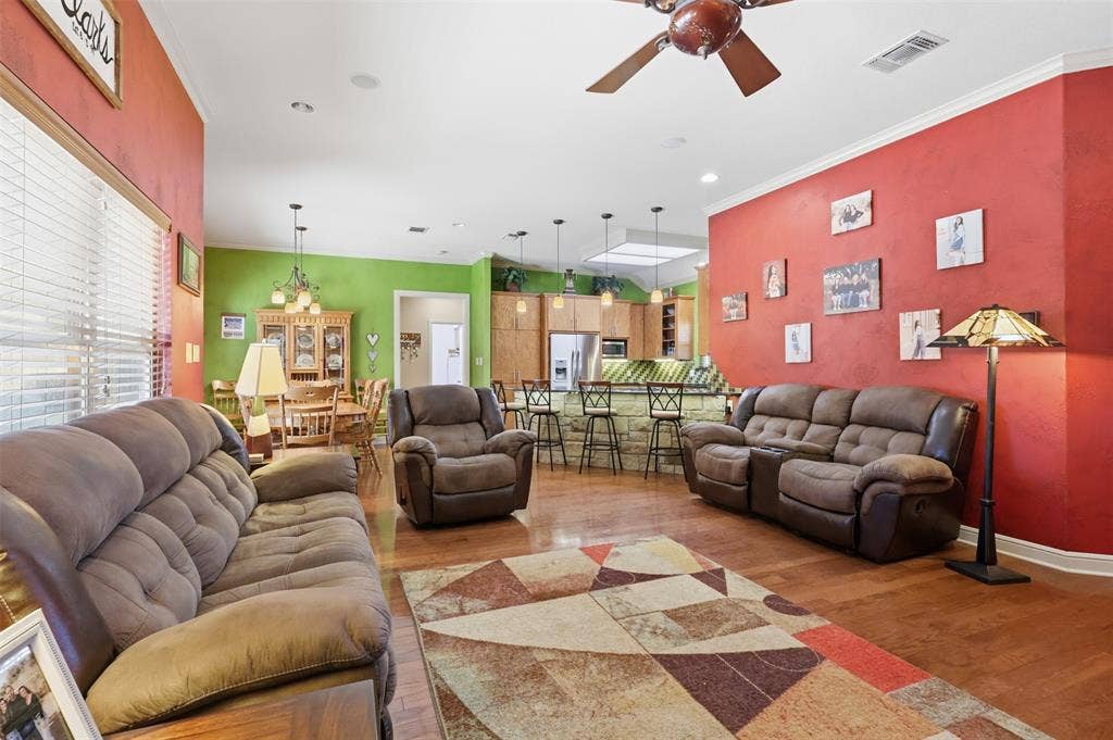 Wood-finish flooring throughout, complemented by a ceiling fan with integrated lighting