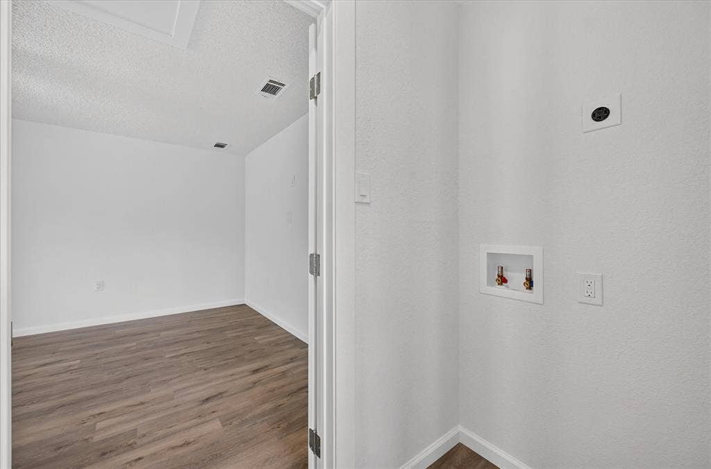 12 States Avenue, Midlothian, TX 76065 Laundry room positioned between the dinning room and bonus room, wired for either a stacked W/D setup or separate!