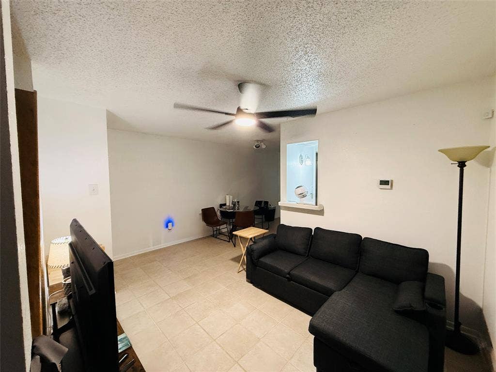 1915 S 10th Street, Waco, TX 76706 Tile flooring, white walls, ceiling fan, and a pass-through window