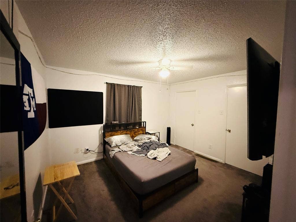 1915 S 10th Street, Waco, TX 76706 Carpeted bedroom featuring a ceiling fan with integrated lighting and two white panel doors