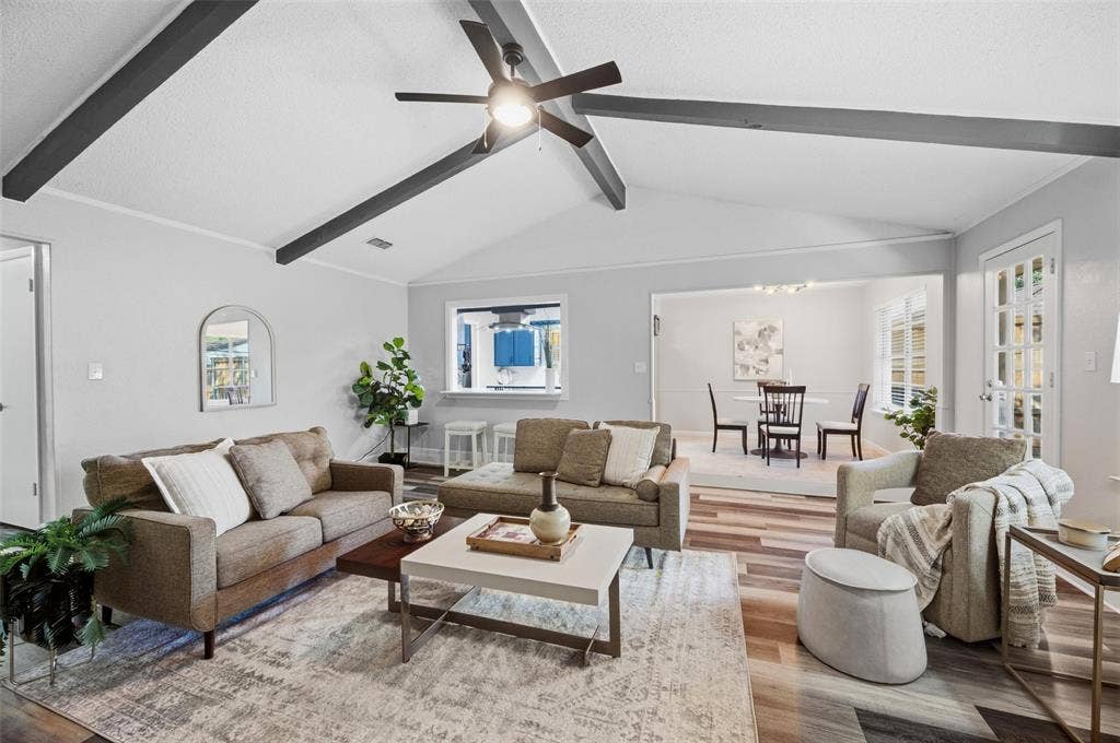Vaulted ceiling with exposed beams, wood-finish flooring, recessed lighting, and a ceiling fan