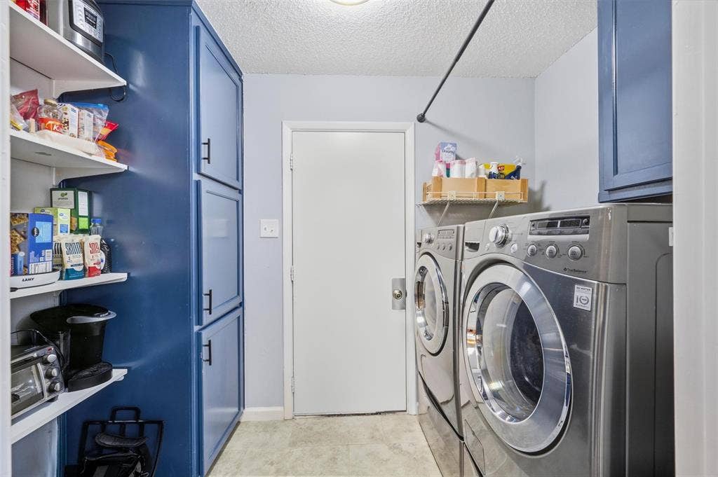 Built-in shelving, blue cabinetry with dark hardware, and a hanging rod