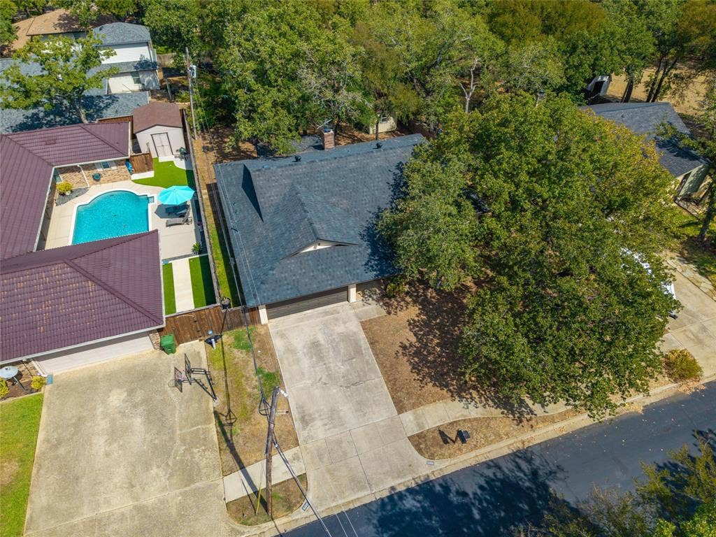 Paved driveway and a mature tree providing natural shade