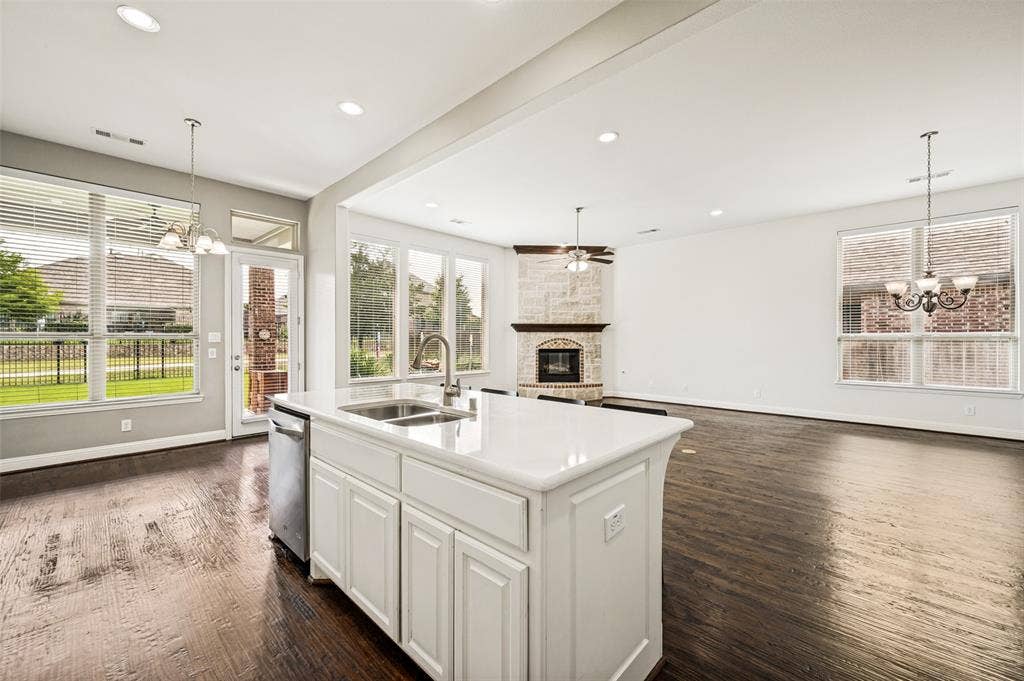 View from Kitchen overlooking wall of windows, living area & breakfast room