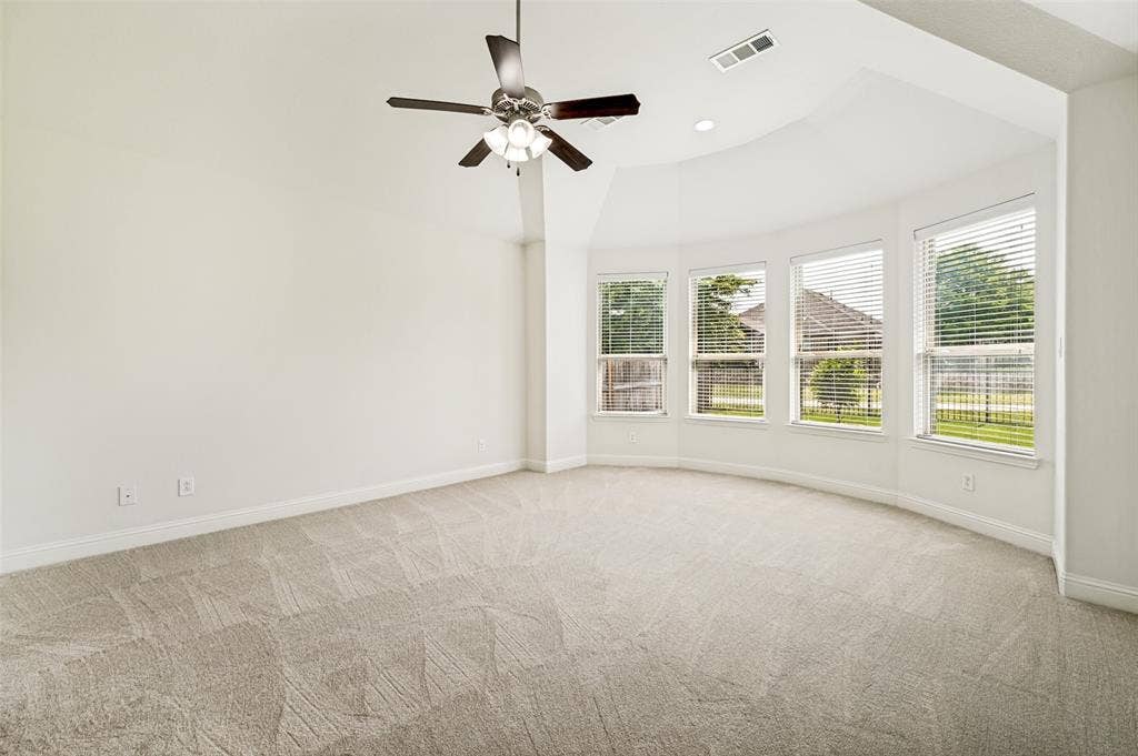 Primary master with new carpet & bay windows overlooking backyard