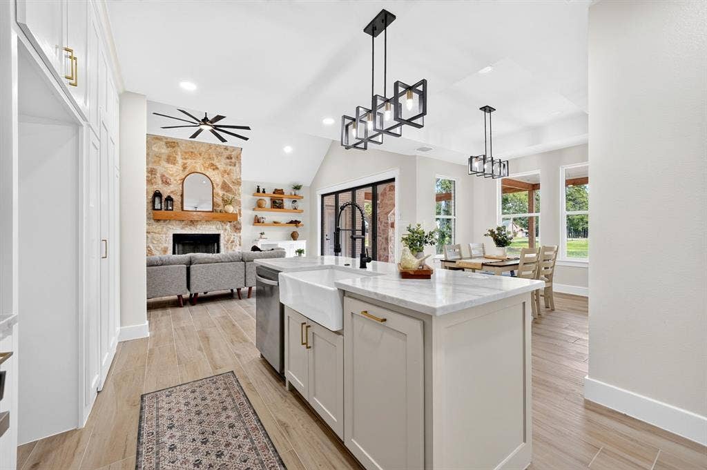 120 Springwood Road, Enchanted Oaks, TX 75156 Central island kitchen with a farmhouse sink and light-toned cabinetry