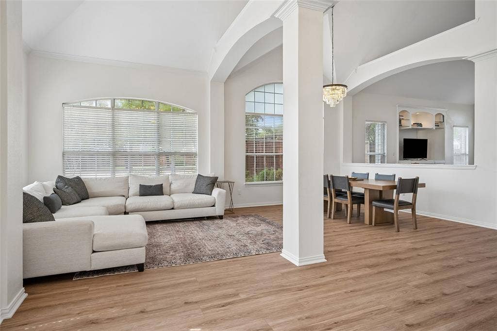 3801 Kite Meadow Drive, Plano, TX 75074 Arched architectural details, wood-finish flooring, high ceilings, and a built-in entertainment center