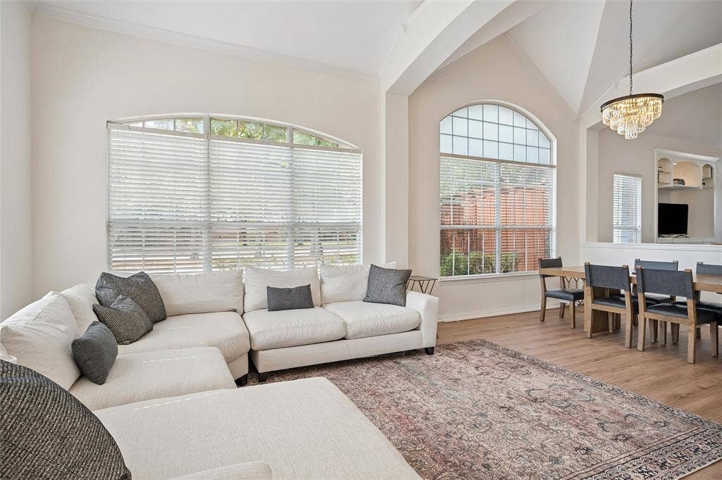 3801 Kite Meadow Drive, Plano, TX 75074 Vaulted ceilings and arched windows illuminate the space, complemented by wood-finish flooring and crown molding