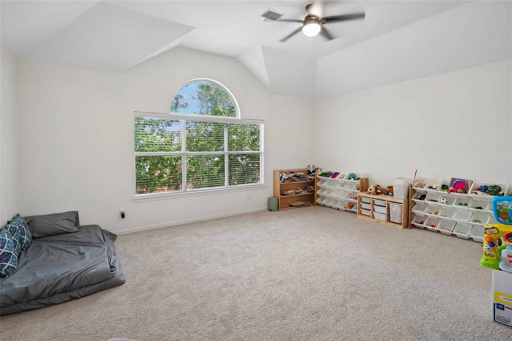 3801 Kite Meadow Drive, Plano, TX 75074 Vaulted ceiling featuring a ceiling fan, large window with blinds, and an arched transom window