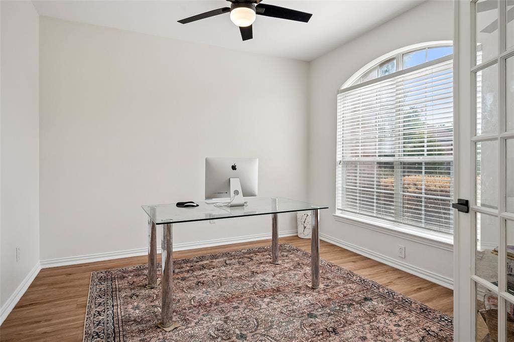 3801 Kite Meadow Drive, Plano, TX 75074 Arched window with blinds, wood-finish flooring, ceiling fan with integrated lighting, and French doors