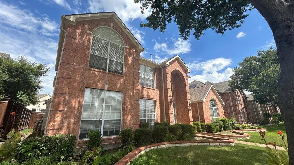 Brick exterior with multiple arched windows and a prominent arched entry