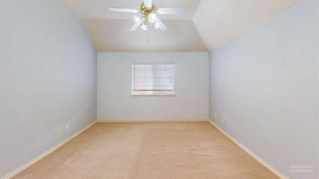 Vaulted ceiling with a ceiling fan light fixture, single window with blinds, and light-toned carpet flooring