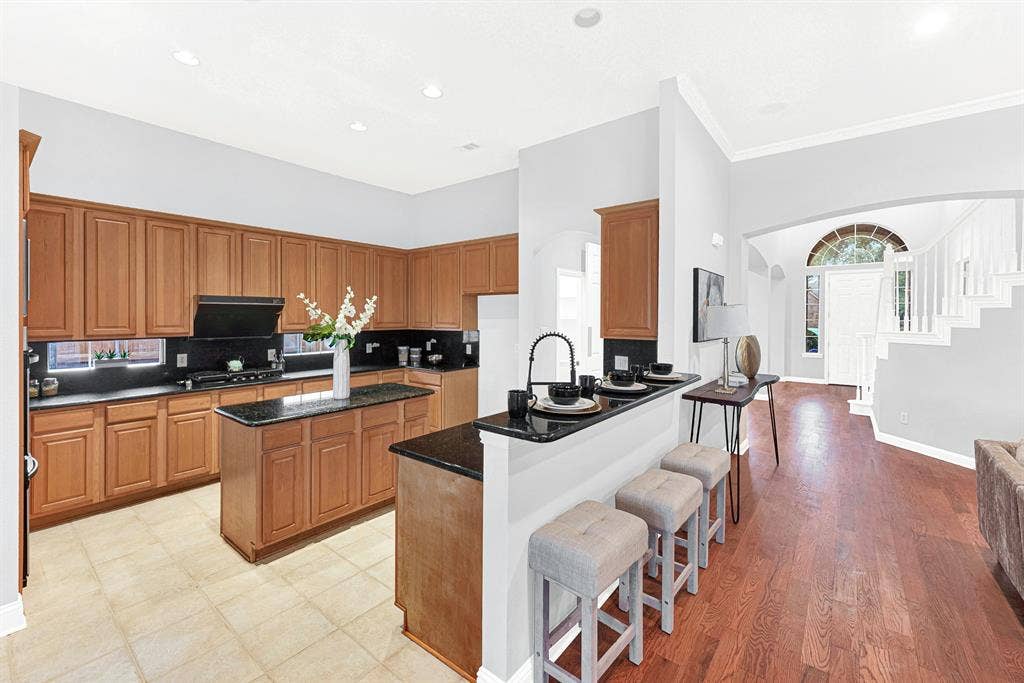 4433 Creekbend Circle, Richardson, TX 75082 Kitchen offers plenty of cabinet and counter space, and a convenient breakfast bar
