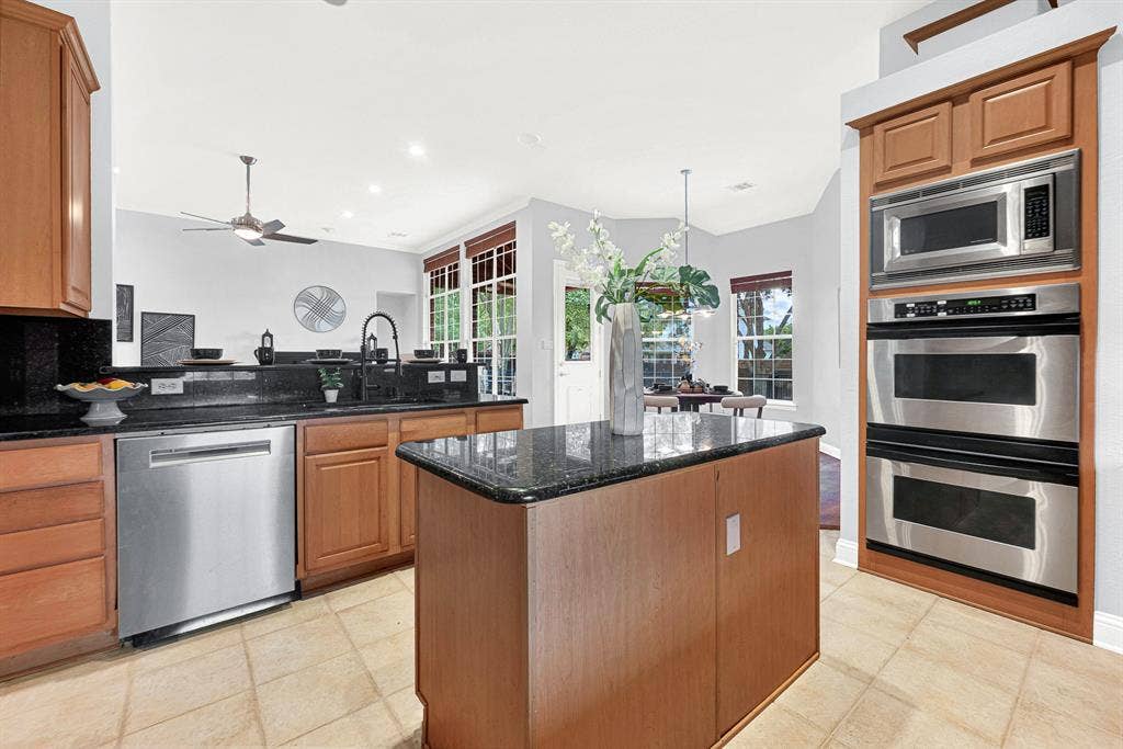 4433 Creekbend Circle, Richardson, TX 75082 Stainless steel appliances, including double oven and built-in microwave