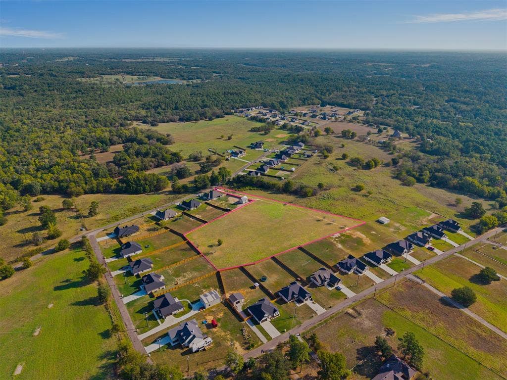 15610 County Road 436, Lindale, TX 75771 Expansive lot with defined boundaries within a developed residential area, featuring surrounding green spaces and mature trees