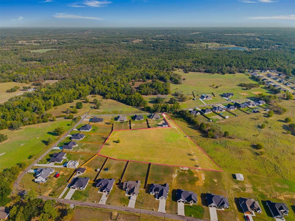 15610 County Road 436, Lindale, TX 75771 Expansive lot with surrounding developed properties, a clear land parcel, and established roadways