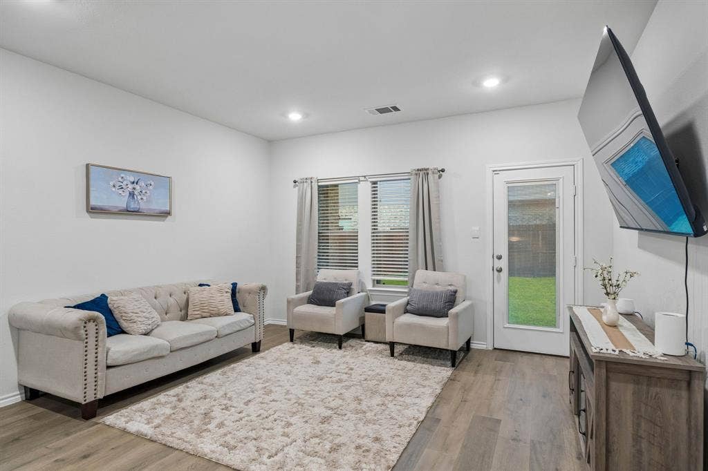3719 Mildren Bend, Crandall, TX 75114 Open-concept living space with recessed lighting and ample natural light from windows to the back yard