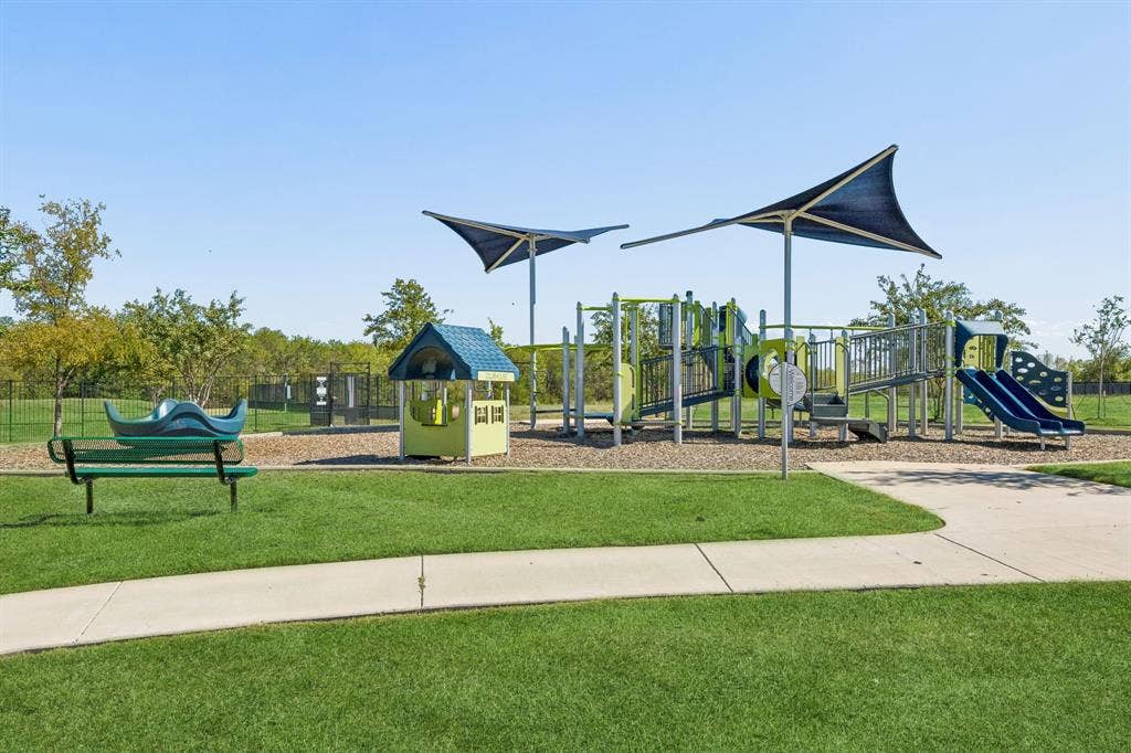 3719 Mildren Bend, Crandall, TX 75114 Community playground featuring multiple slides, climbing structures, and shade canopies