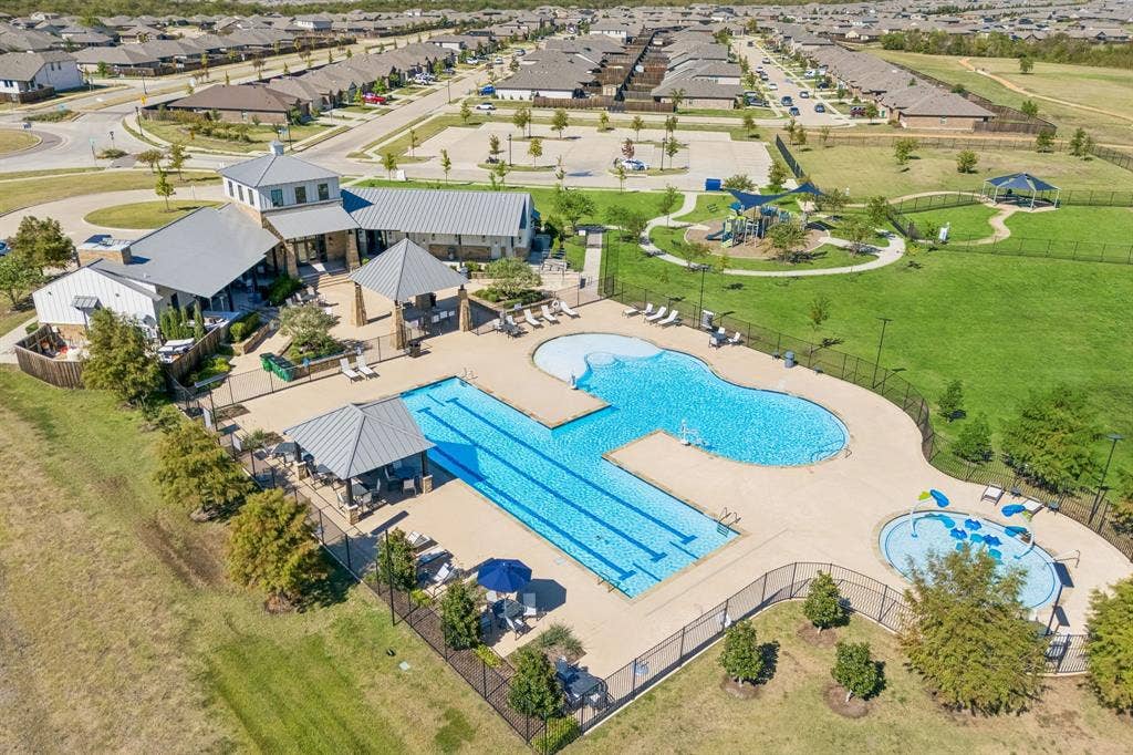 3719 Mildren Bend, Crandall, TX 75114 Community swimming pool with lap lanes, adjacent splash pad, and multiple covered cabanas