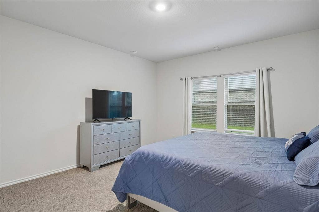 3719 Mildren Bend, Crandall, TX 75114 The primary suite is at the back of the home and features a great view of the back yard.
