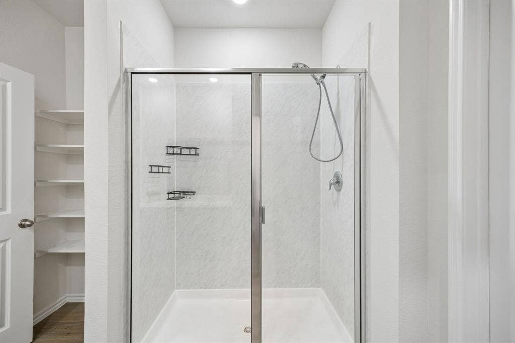 3719 Mildren Bend, Crandall, TX 75114 Walk-in shower with clear glass enclosure, notice the open storage to the left
