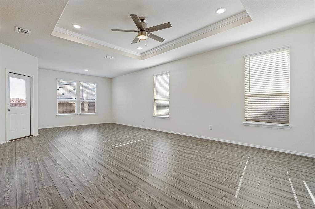 Living and dining areas have an abundance of natural light and a decorative tray ceiling for added elegance