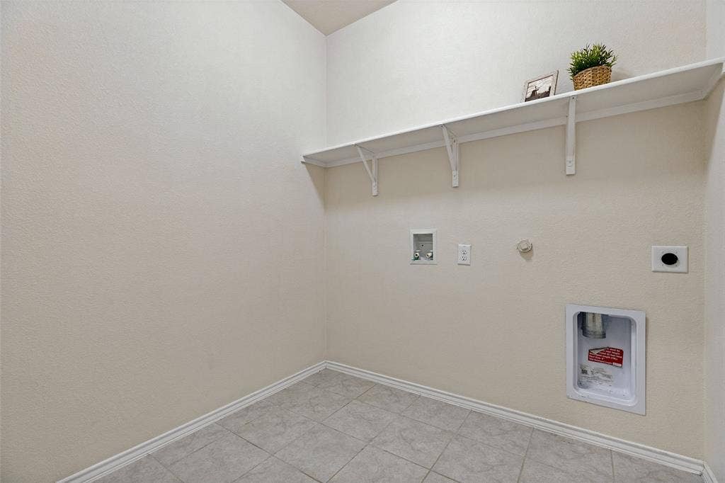 Oversized laundry room with plenty of space for freezer or storage