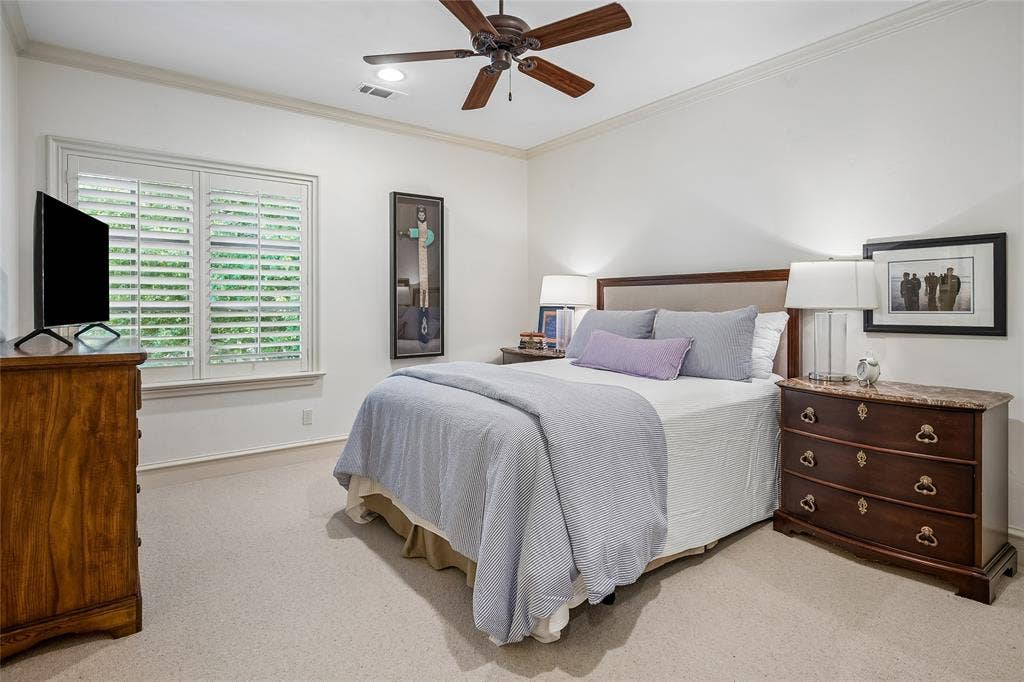 5222 Stonegate Road, Dallas, TX 75209 Bedroom suite #3 Window with plantation shutters, ceiling fan, crown molding, and neutral-toned wall paint