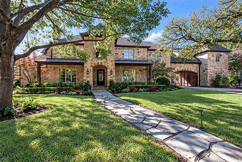 5222 Stonegate Road, Dallas, TX 75209 Stone exterior with arched entry, complementing stone walkway, and mature landscaping