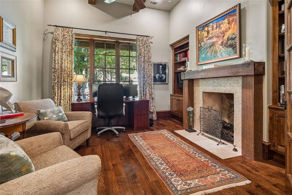 5222 Stonegate Road, Dallas, TX 75209 Handsome office or library -Hardwood flooring, fireplace with stone surround and wood mantel, built-in shelving, vaulted ceiling, and wood-frame window