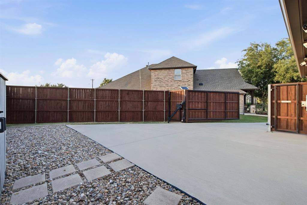 EXTRA DRIVEWAY CONCRETE SPACE THAT IS ALL FENCED IN