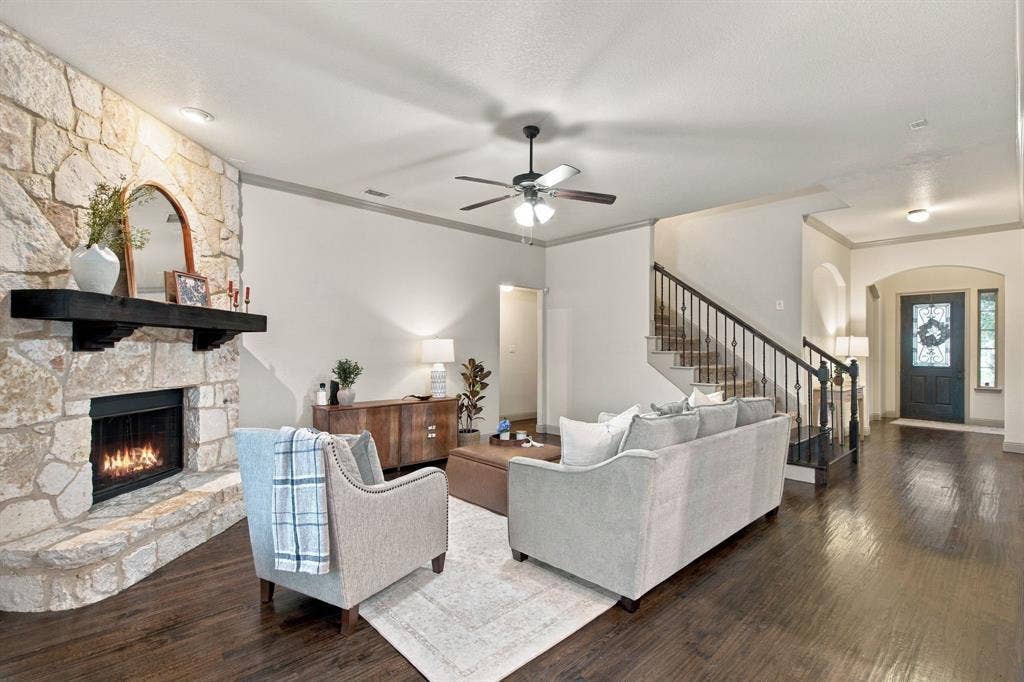 COZY LIVING ROOM WITH STONE FIREPLACE AND LIGHT AND BRIGHT WALLS