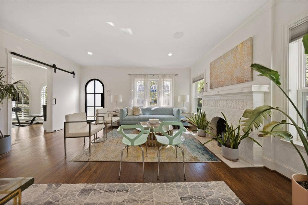 5709 Kenwood Avenue, Dallas, TX 75206 Hardwood flooring, decorative fireplace, recessed lighting, double windows, and barn door entry