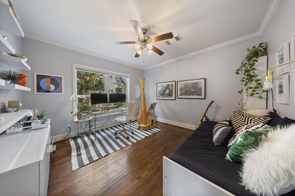 5709 Kenwood Avenue, Dallas, TX 75206 Hardwood-finish flooring throughout, crown molding, a ceiling fan with integrated lighting, and a large window