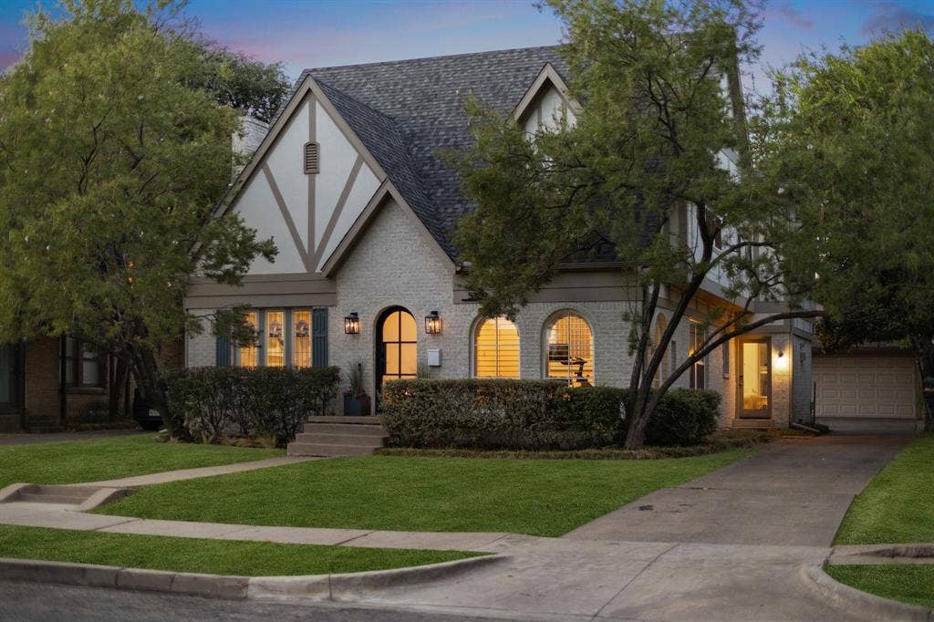 5709 Kenwood Avenue, Dallas, TX 75206 Tudor-style facade with a gabled roof, arched entryway, and stone exterior