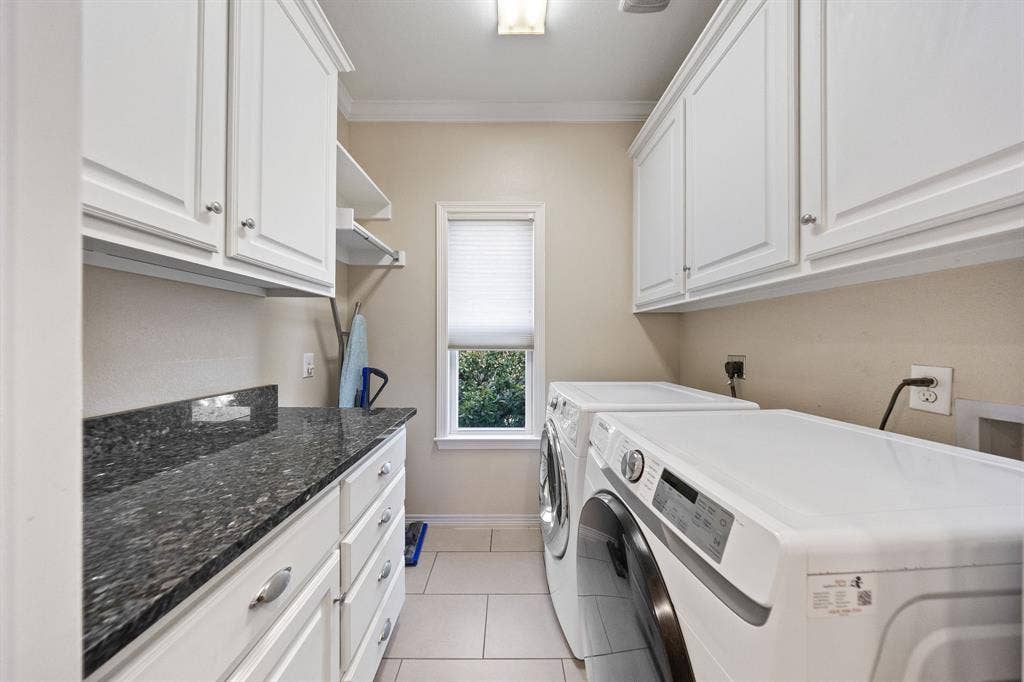 5709 Kenwood Avenue, Dallas, TX 75206 White cabinetry with brushed nickel hardware, dark speckled countertop, single window with blinds, overhead lighting, and tile flooring