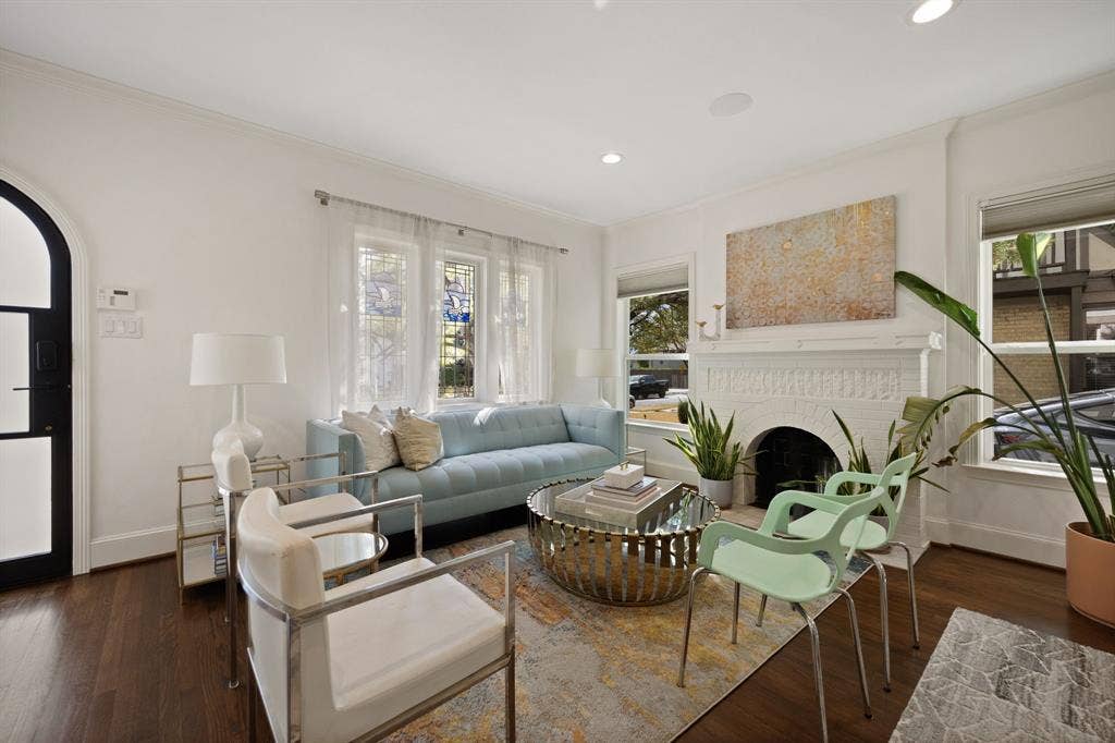 5709 Kenwood Avenue, Dallas, TX 75206 Hardwood flooring, decorative fireplace, recessed lighting, arched entryway, and multiple windows